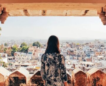 Woman looking at the city of Udaipur from a viewpoint